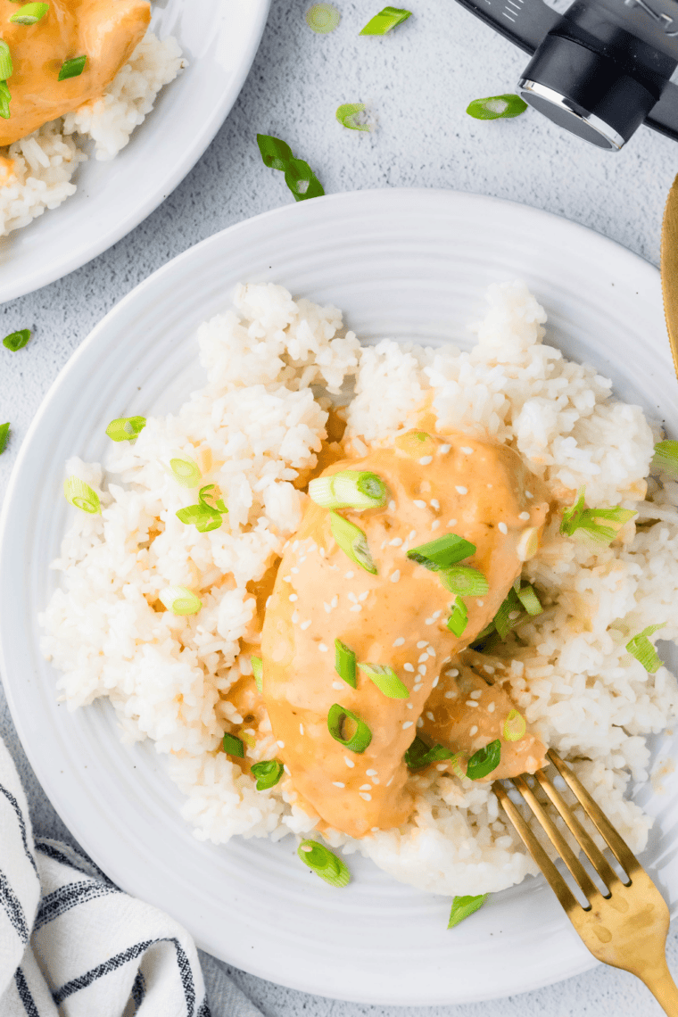 Creamy slow cooker bang bang chicken served over rice with sweet spicy sauce.