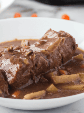 Slow cooker beef sirloin tip roast served with rich, savory gravy and herbs.