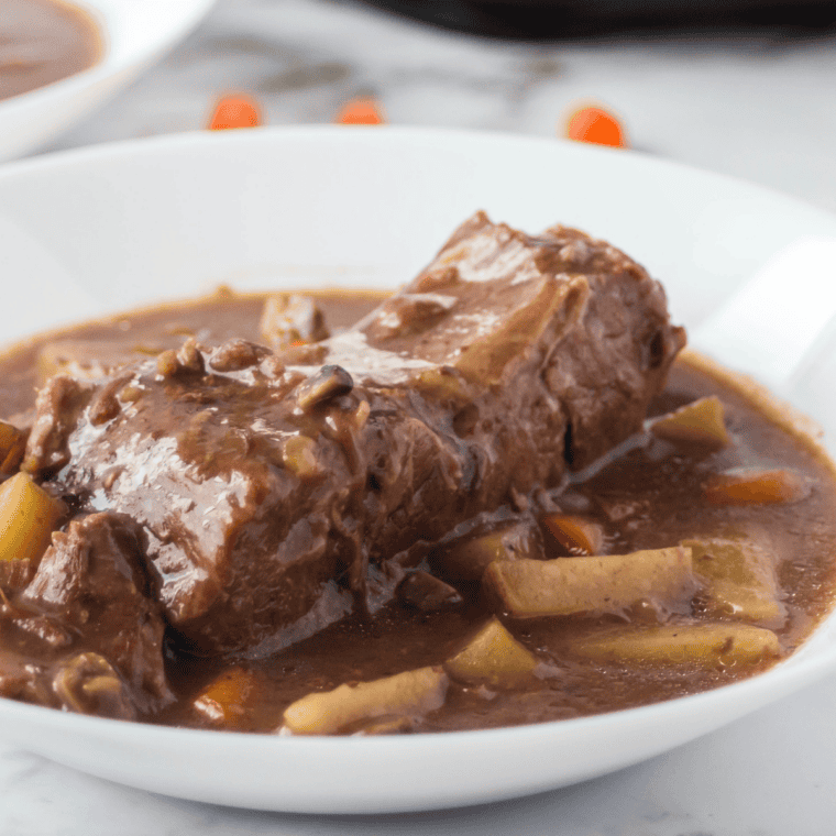 Slow cooker beef sirloin tip roast served with rich, savory gravy and herbs.
