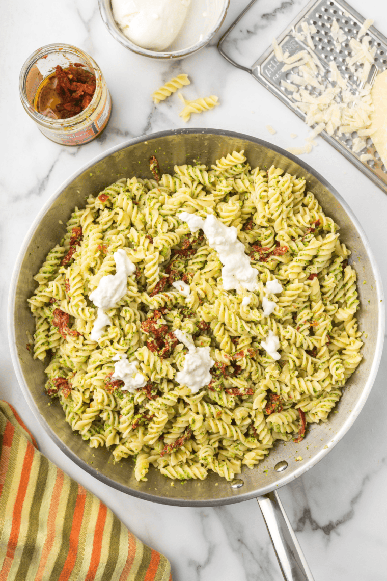 Creamy Trader Joe’s broccoli fusilli pasta bake topped with melted cheese in a baking dish.