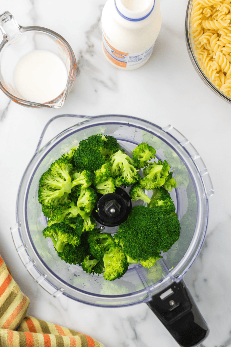 Blanching broccoli in salted water then shocking in cold water, puréeing with cream and milk.