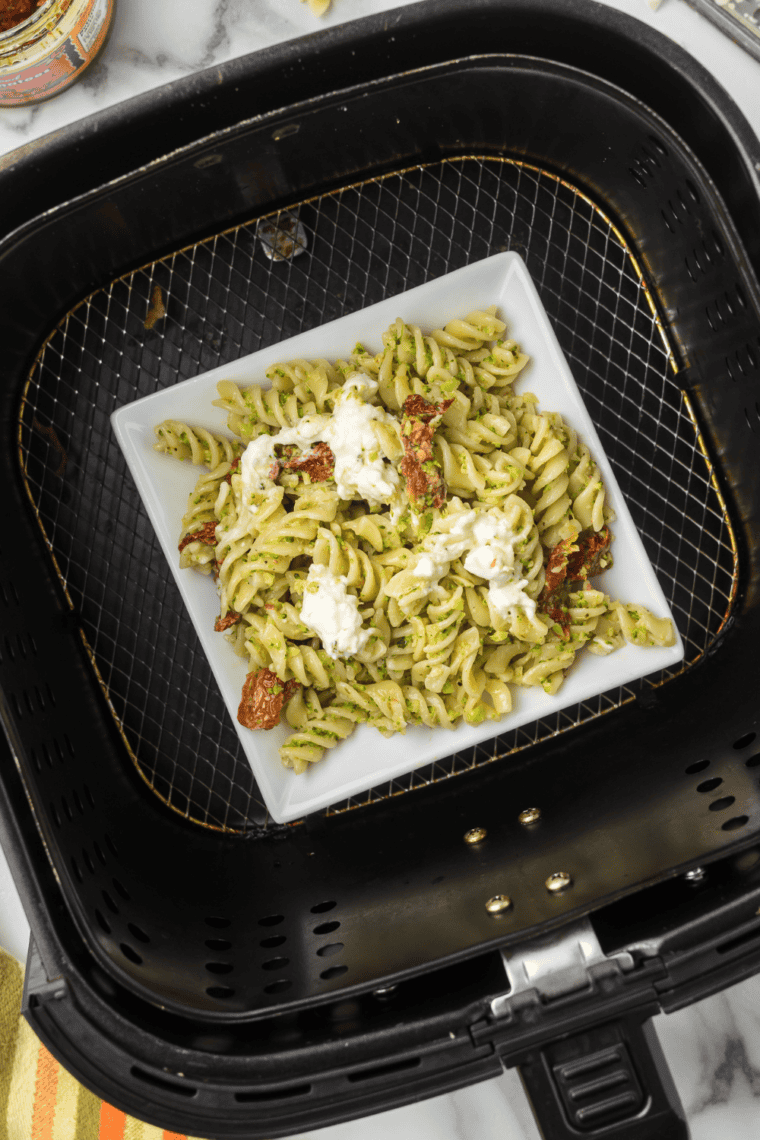 Serving pasta with melted burrata, seasoned with salt, pepper, red pepper flakes, and optional olive oil drizzle.