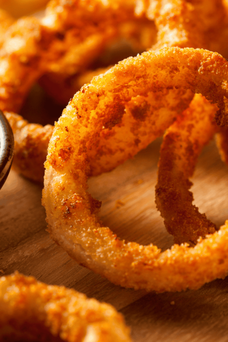 Homemade Long John Silver’s style onion rings with crispy golden batter served on a plate.