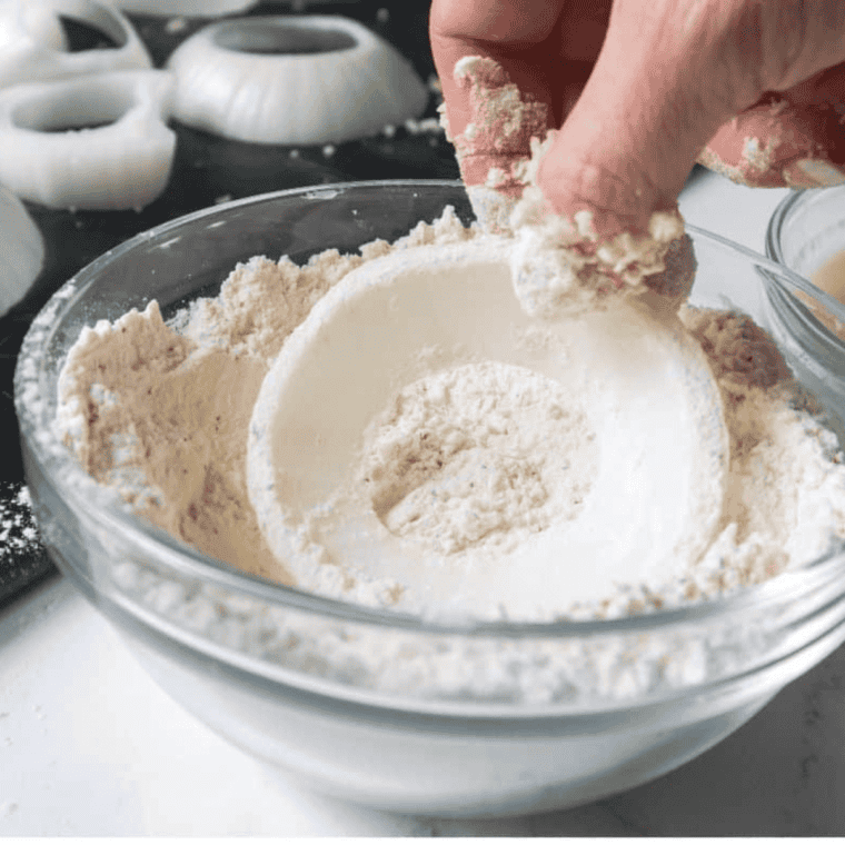 Dip the onion rings into the dry batter.