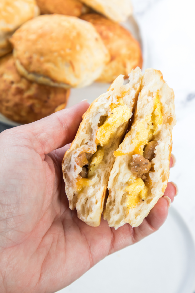 stacked monster biscuit breakfast sandwich with bacon sausage ham egg and cheese