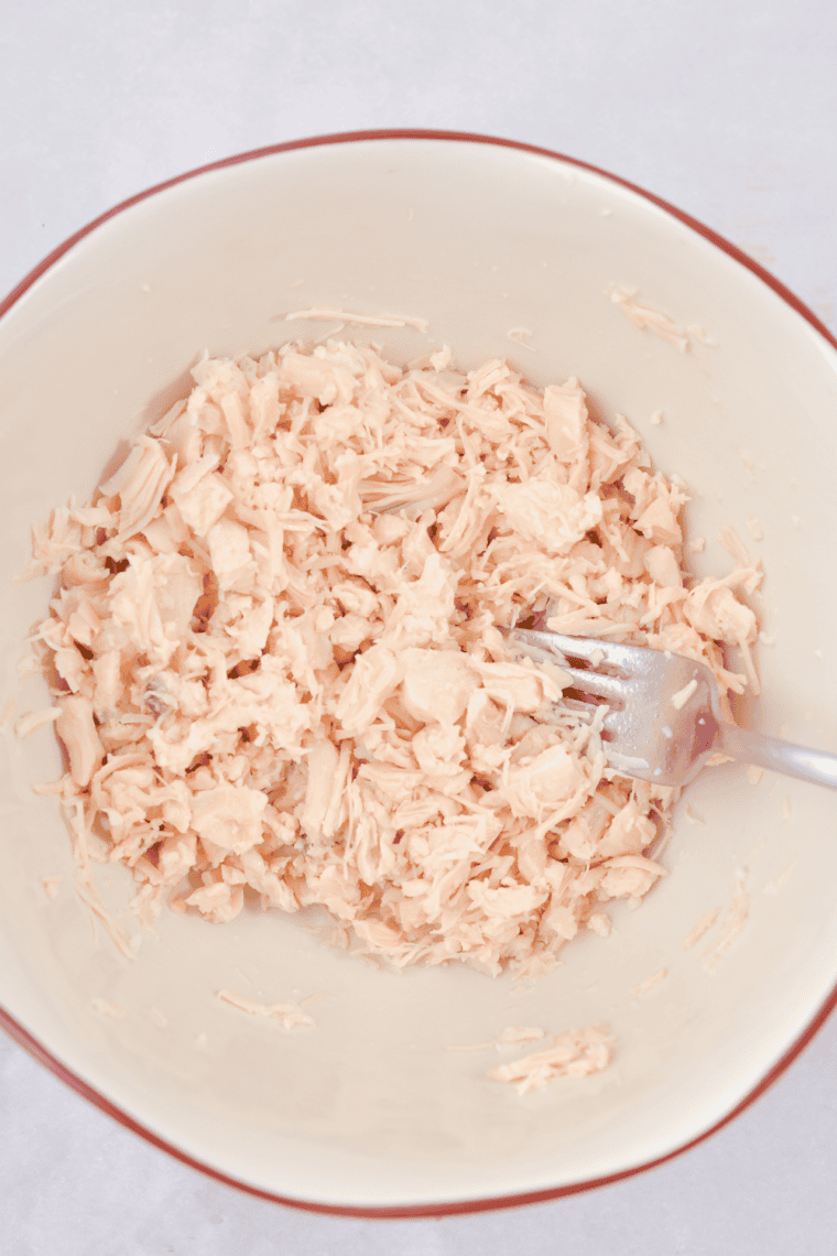 Chicken tenderloins gently poached in simmering water or broth in a pot, cooked until 165°F for tender, juicy texture.