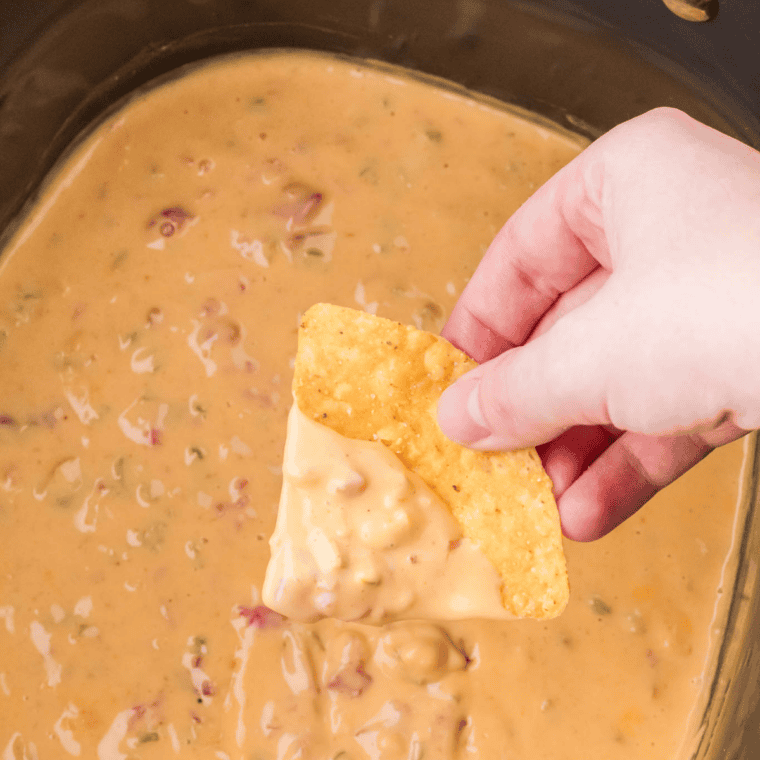 easy crockpot cream cheese dip warm and melty served in slow cooker with tortilla chips