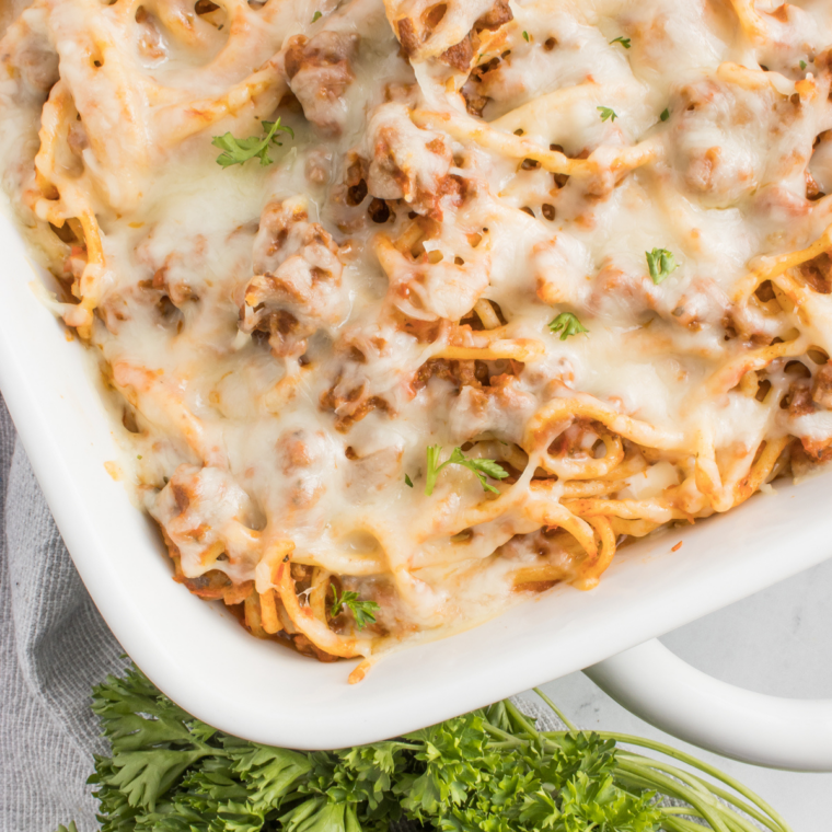 Baked spaghetti casserole with marinara sauce, melted cheese, and pasta baked in a dish like Fazoli’s copycat recipe.