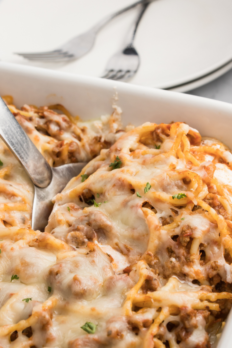 Baked spaghetti casserole inspired by Fazoli’s with layers of pasta, meat sauce, and melted mozzarella cheese baked until golden and bubbling.