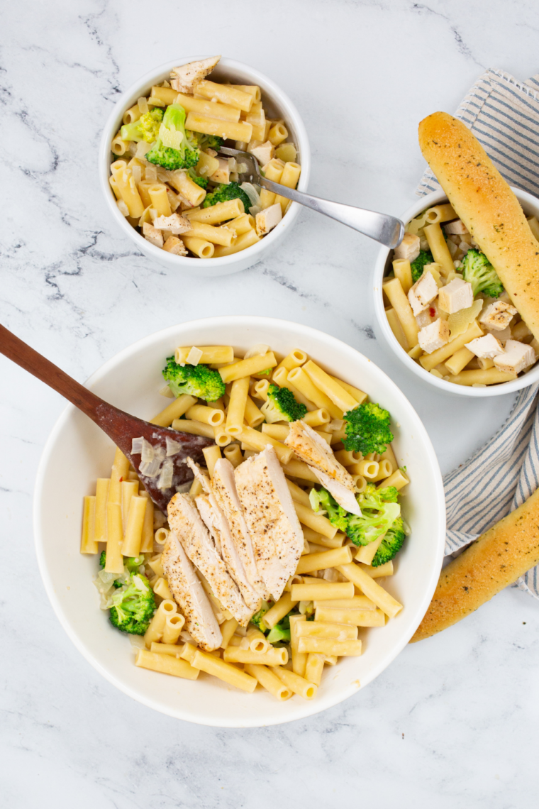 Baked chicken broccoli penne inspired by Fazoli’s with creamy Alfredo sauce, tender chicken, roasted broccoli, and melted cheese on top