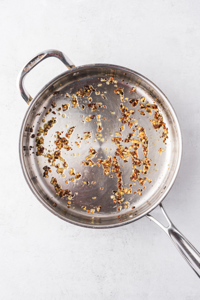 Sautéing diced onions in olive oil until soft and translucent for sauce base