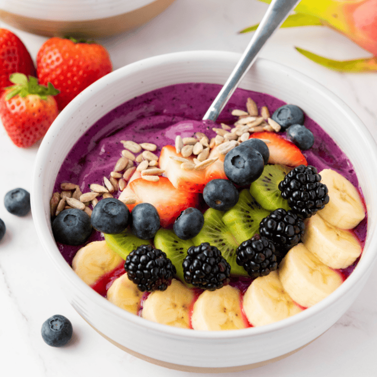 Chia pudding bowl inspired by First Watch topped with fresh berries, granola, and nuts in a glass jar for a healthy superfood breakfast.