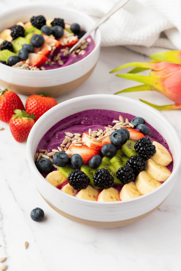 Glass jar chia pudding bowl inspired by First Watch topped with fresh berries, granola, nuts, and honey for a healthy superfood breakfast.