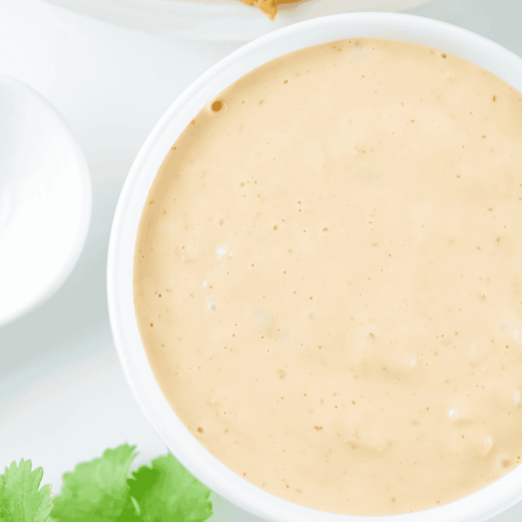 Creamy Gordon Ramsay peppercorn sauce in a skillet with cracked black peppercorns, butter, cream, and herbs creating a rich steakhouse-style sauce.