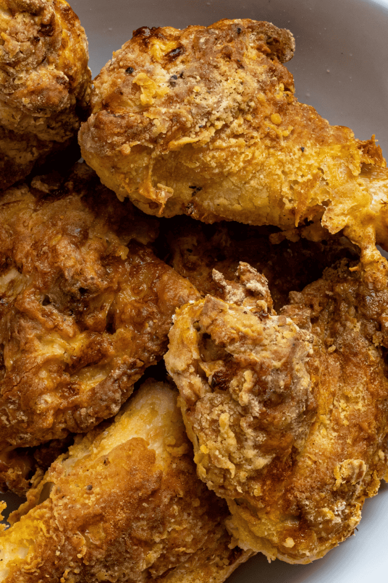 Chicken frying in hot oil until golden brown and crispy exterior finishes cooking