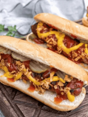 Hot dogs cooking in an Instant Pot, steaming and heated through, ready to serve in soft buns with toppings.