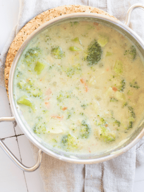 Bowl of creamy McAlister’s Broccoli and Cheddar Soup topped with melted cheddar and tender broccoli florets in a thick, cheesy base.