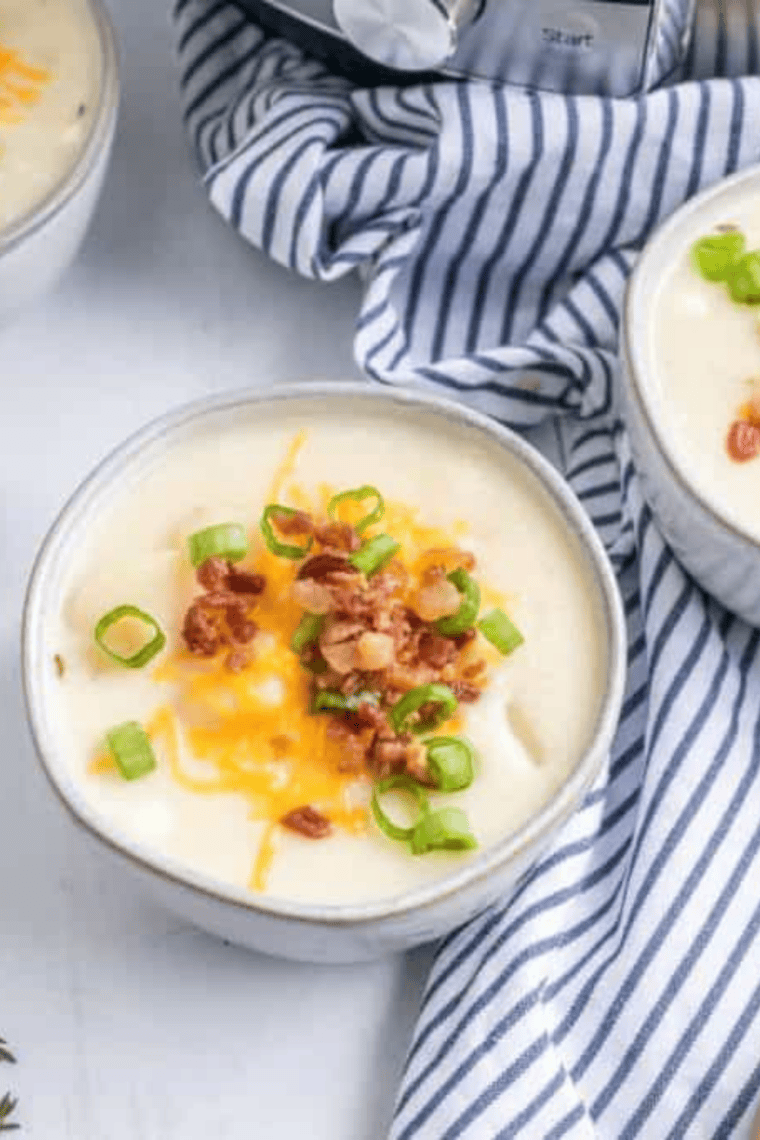 Creamy loaded McAlister’s potato soup in a bowl topped with bacon, shredded cheese, and green onions, rich copycat comfort soup recipe.
