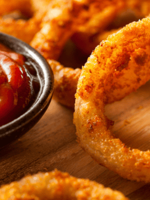 Homemade Red Robin spicy ketchup served in a small bowl with crispy fries for dipping, rich red sauce with a hint of spice