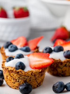 Red white and blue granola berry cups layered with fresh berries and crunchy granola in clear cups