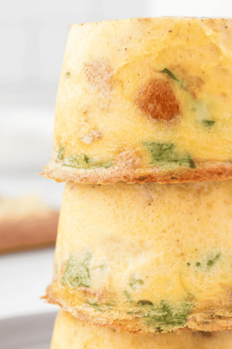 Fluffy baked Scooter’s style egg bites made with eggs, cheese, and mix-ins served warm on a plate for a quick protein breakfast or meal prep snack.