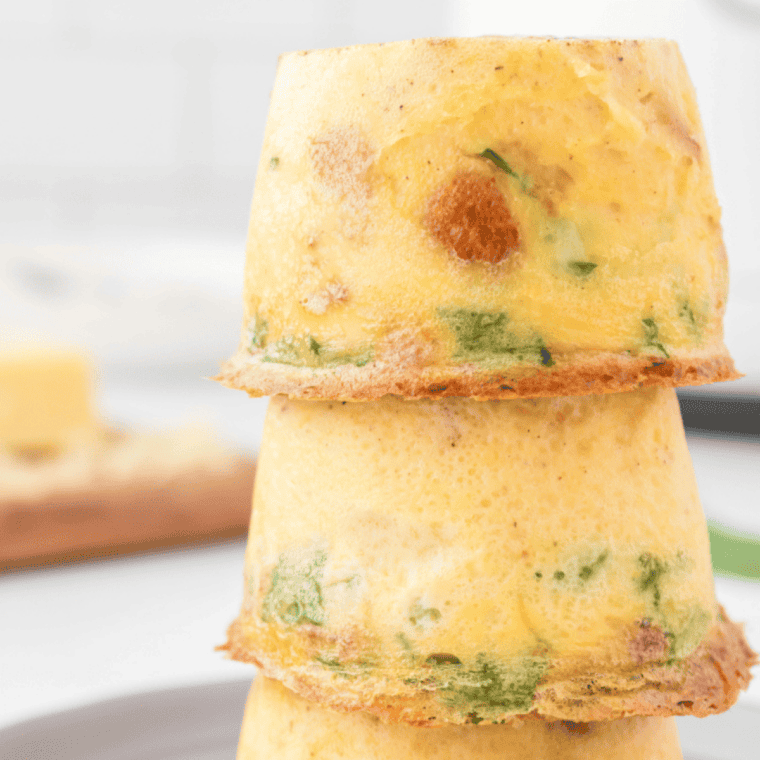 Fluffy baked Scooter’s style egg bites made with eggs, cheese, and mix-ins served warm on a plate for a quick protein breakfast or meal prep snack.