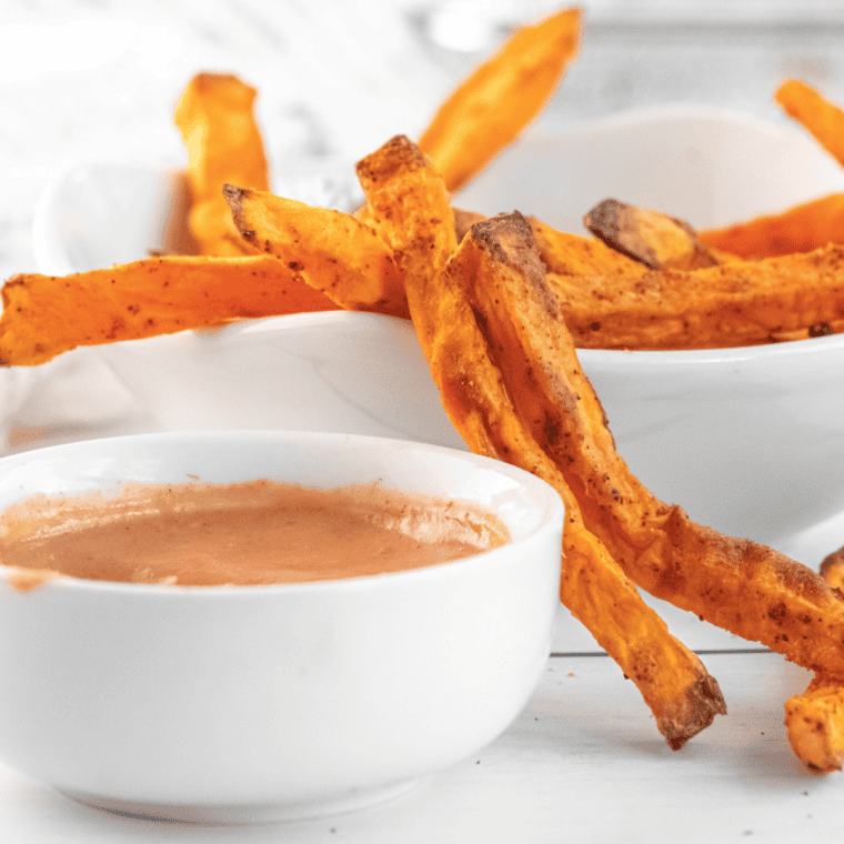 Small bowl of creamy Sonic Groovy Sauce served with fries and chicken tenders for dipping.