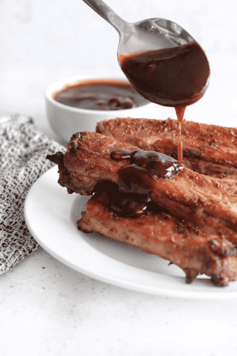 Homemade Wood Ranch BBQ sauce in a bowl with rich smoky red color, perfect for grilled meats, ribs, and burgers