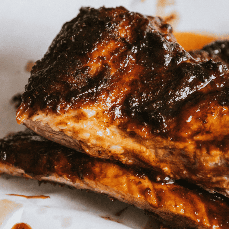 Plated beef ribs from the air fryer with a rich glaze and charred edges.