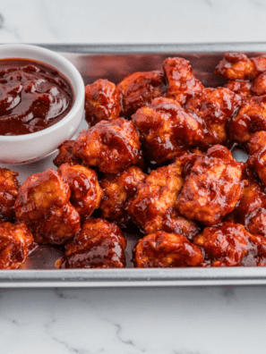Homemade Burger King BBQ sauce served in a small dipping bowl beside chicken nuggets.