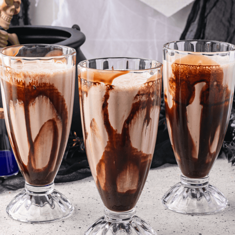 Close-up of caramel macchiato milkshake with whipped topping and caramel syrup