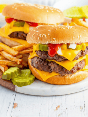 Finished copycat McDonald's Double Cheeseburger with two smashed beef patties, melted American cheese, pickles, and onions on a soft steamed bun