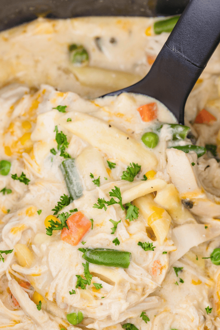 Bowl of creamy Crock Pot Chicken Pot Pie Pasta with shredded chicken, vegetables, and pasta noodles.