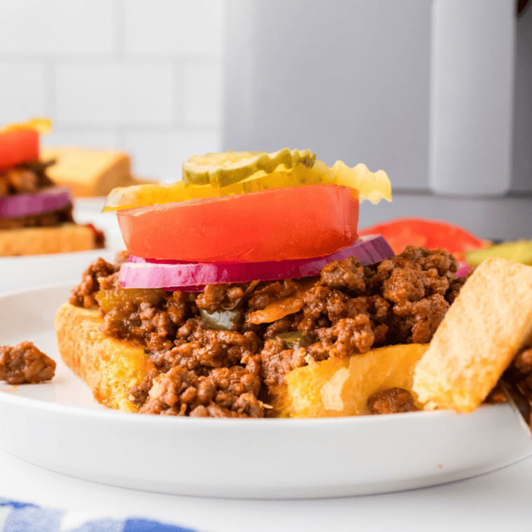 Close-up of homemade sloppy joe mix simmering in a skillet with ground beef and rich tomato sauce.