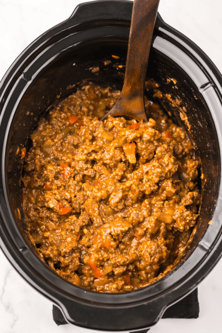 Skillet of Sloppy Joe meat mixture bubbling with ground beef, onions, and thick tomato sauce.
