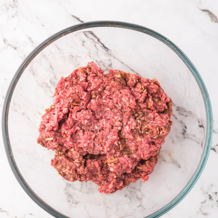 Dividing ground beef into small loose balls for thin McDonald’s style burger patties