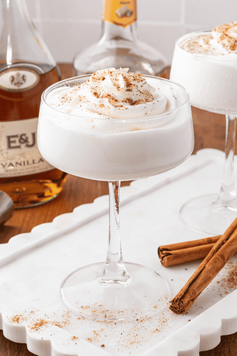 Blended frozen Brandy Alexander cocktail in a coupe glass with whipped cream and chocolate dusting