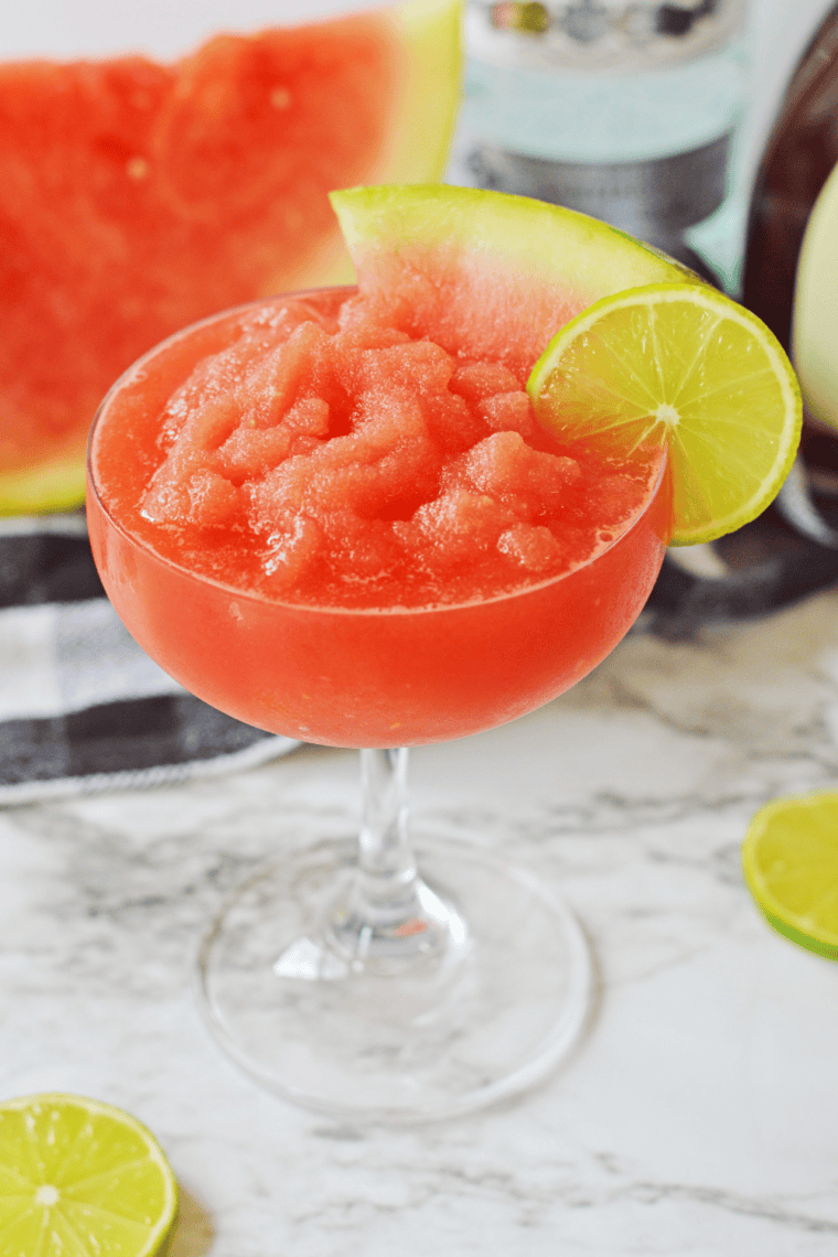 Frosty watermelon daiquiri served in a glass with a chilled slushy texture and fresh watermelon garnish.