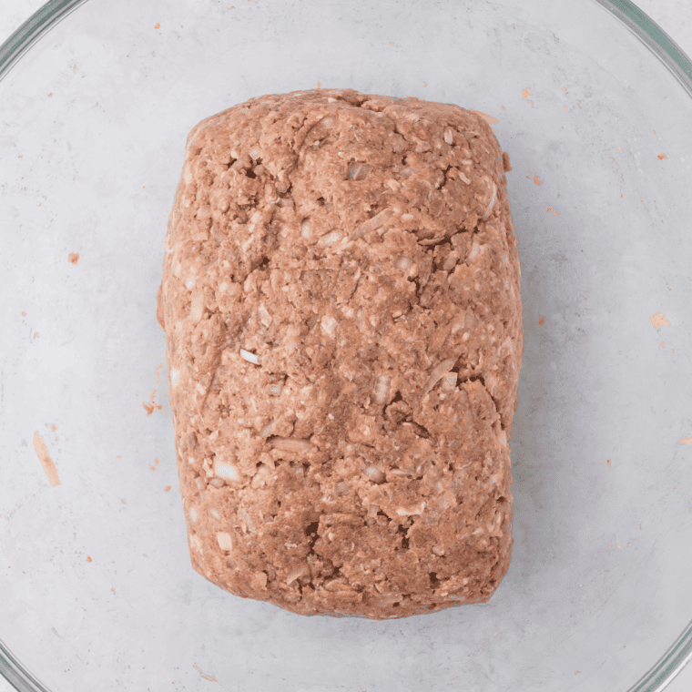Shape and Bake
Hand-shaped one pound meatloaf, about eight inches long, on a foil-lined sheet pan ready to bake at 375 degrees.