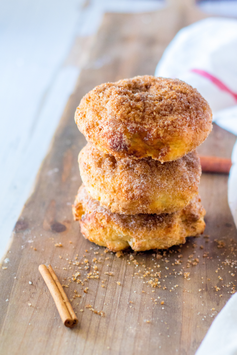 Homemade Panera Copycat Cinnamon Crunch Bagels stacked on a wooden board