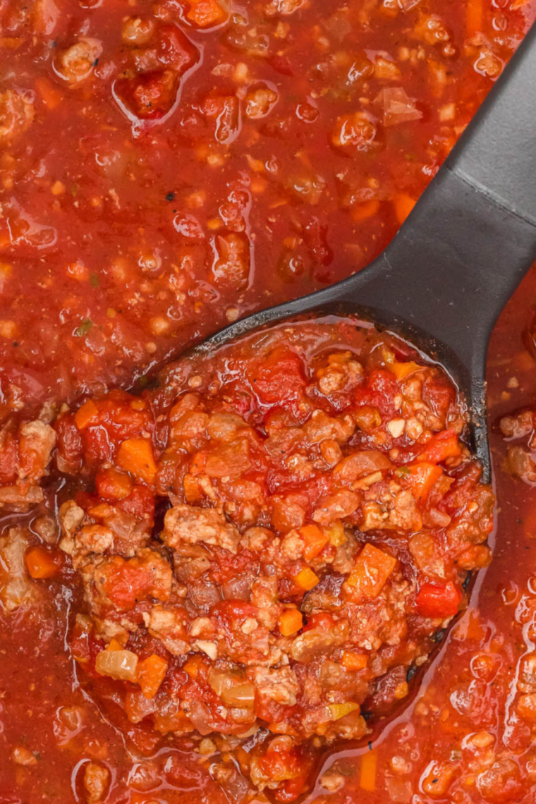 Hearty slow cooker bolognese sauce served over spaghetti