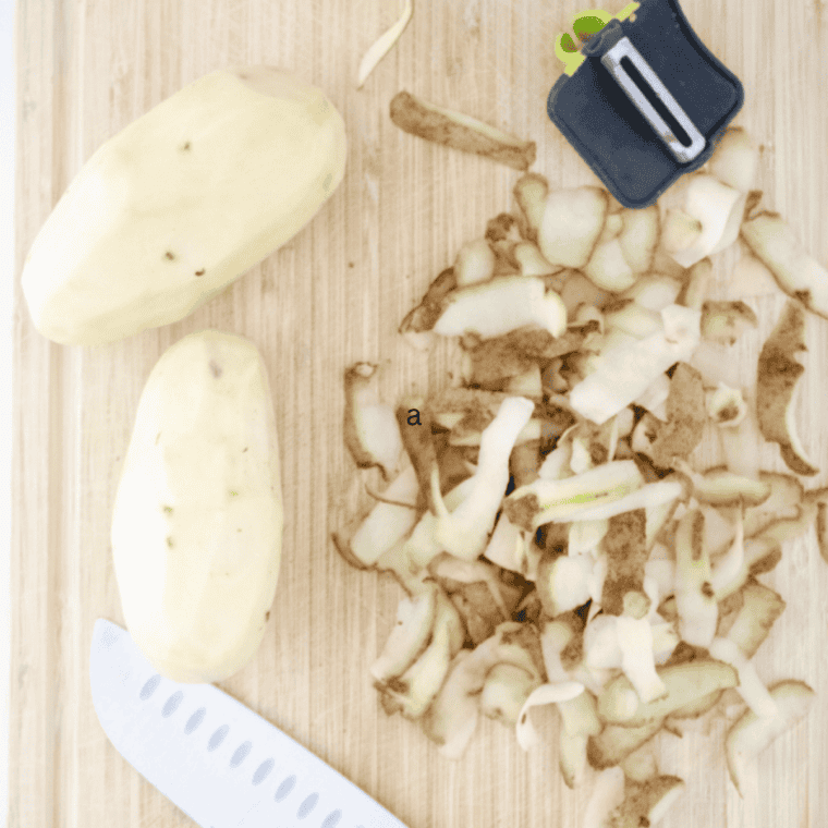 Diced potatoes tossed in melted butter in a large mixing bowl