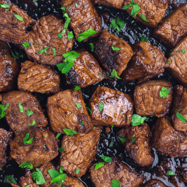 Steak marinating in a caramel-colored Bourbon Brown Sugar Marinade in a resealable bag, ready for grilling