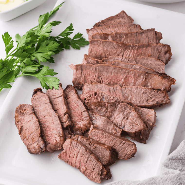 Ribeye steak coated in a dark Coffee Chili Marinade with chili powder and brown sugar in a shallow dish