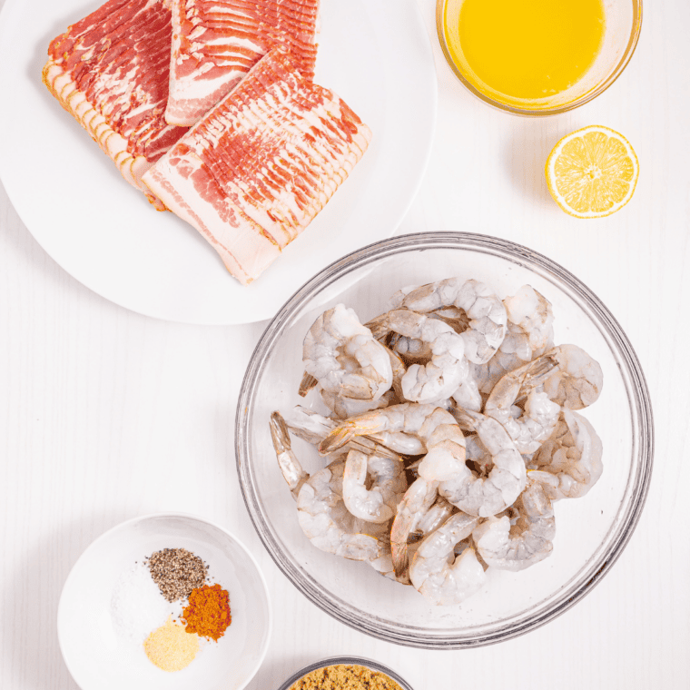 Ingredients for bacon wrapped shrimp with cream cheese — raw shrimp, bacon, cream cheese, jalapeño, and chili sauce