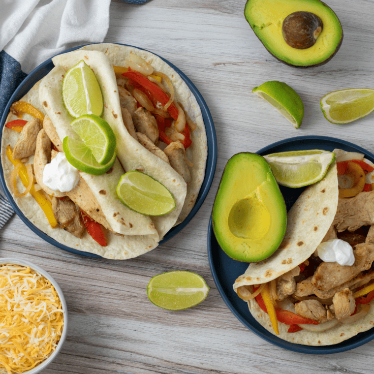 Blackstone chicken fajitas with charred peppers and onions in a warm flour tortilla