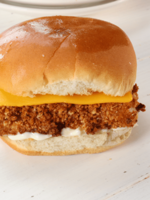 Homemade copycat Burger King fish sandwich cut in half showing the crispy panko pollock fillet inside