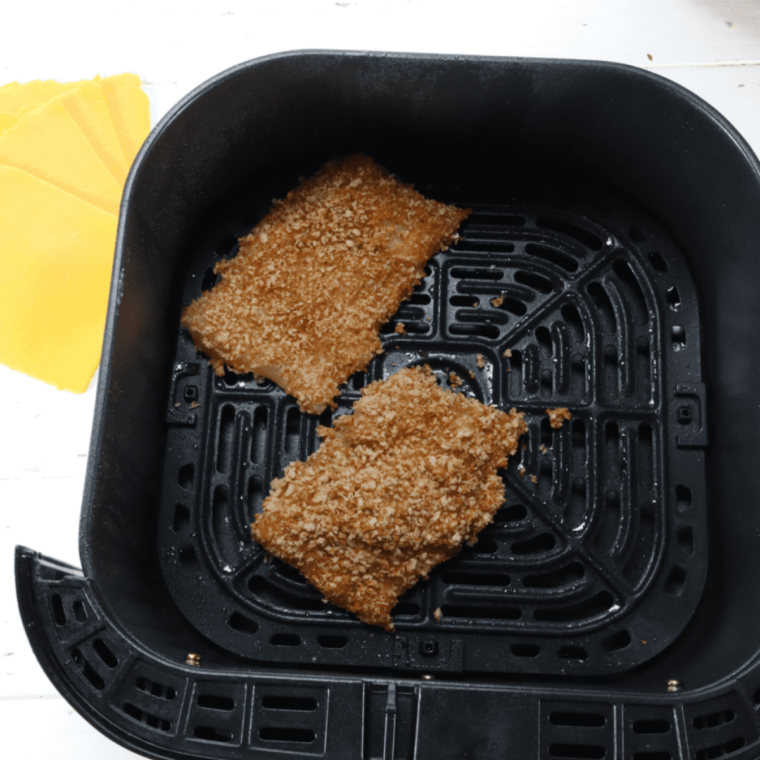 Frozen breaded pollock fillets baking on a sheet pan for a copycat Burger King fish sandwich