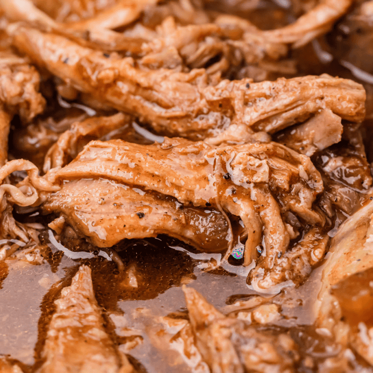 Close-up of shredded smoked pork in a bowl with a sweet and smoky dry rub