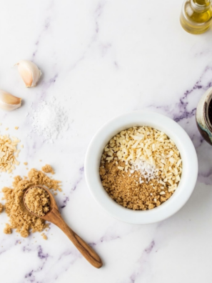 Homemade Lawry’s seasoned salt blend in a small jar with spices scattered around.